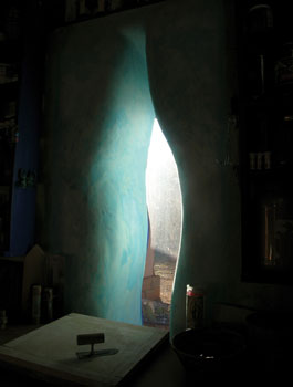 A straw bale wall is finished with lime plaster colored with copper sulfate